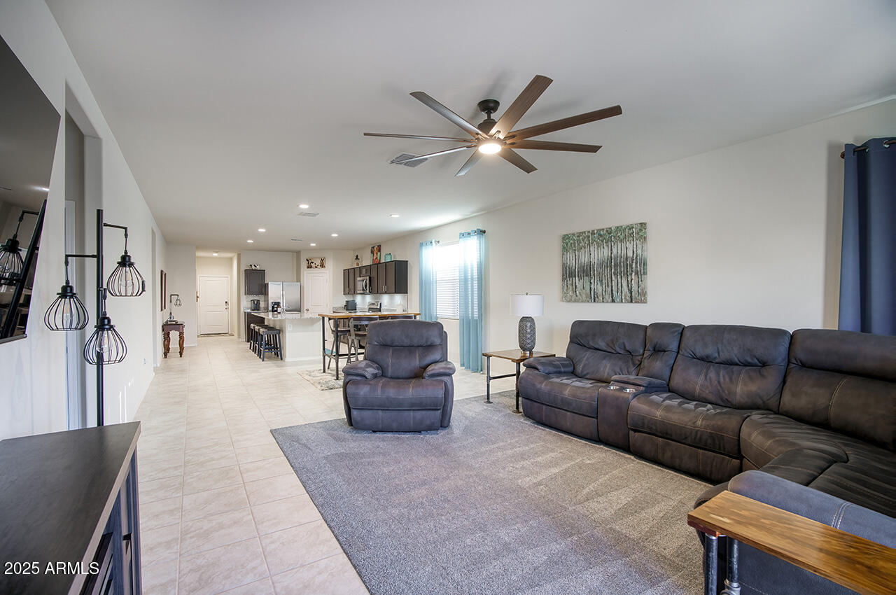 5236 East Emery Road San Tan Valley, AZ 85143 - Photo 9 of 24 a living room with furniture and a chandelier
