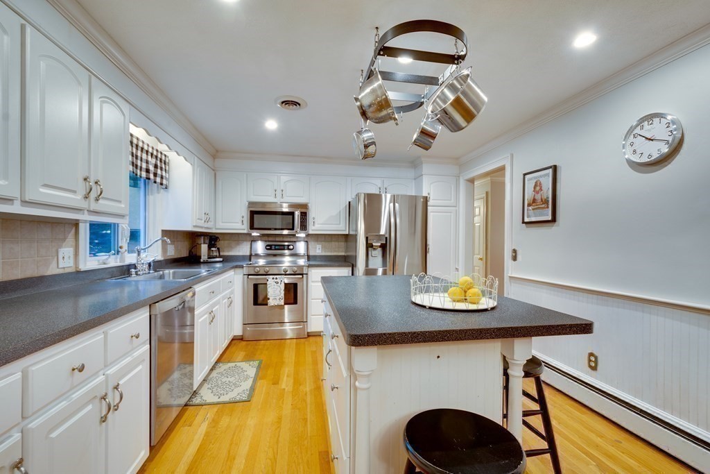 11 Milepost Road Reading, MA 01867 - Photo 1 of 29 a kitchen with stainless steel appliances granite countertop a sink a stove top oven a counter space and cabinets