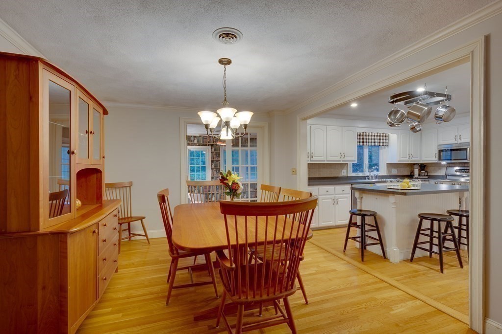 11 Milepost Road Reading, MA 01867 - Photo 11 of 29 a view of a dining room with furniture and wooden floor