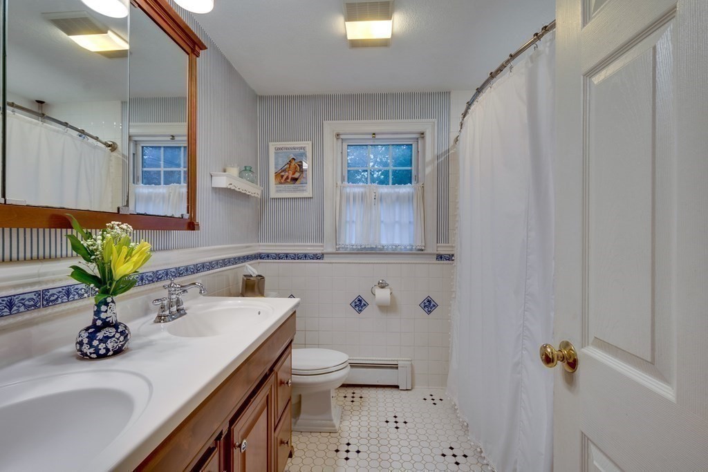 11 Milepost Road Reading, MA 01867 - Photo 19 of 29 a bathroom with a sink a toilet and mirror