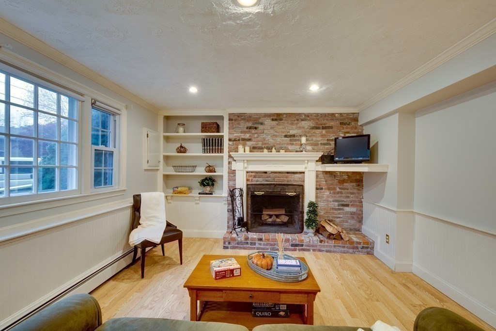 11 Milepost Road Reading, MA 01867 - Photo 20 of 29 a living room with furniture and a fireplace