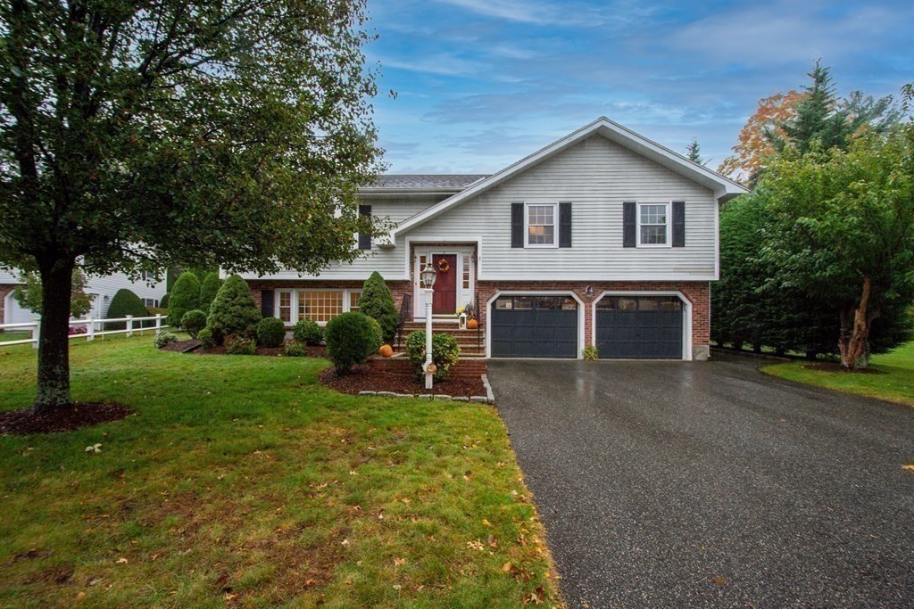 11 Milepost Road Reading, MA 01867 - Photo 2 of 29 a front view of house with yard and green space