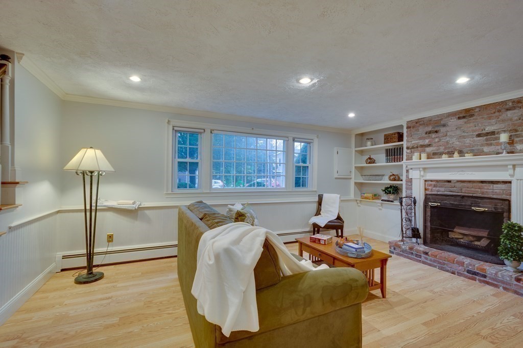 11 Milepost Road Reading, MA 01867 - Photo 22 of 29 a living room with furniture a window and fireplace