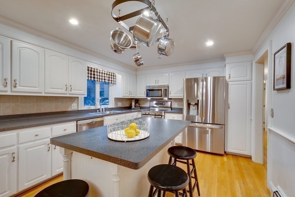 11 Milepost Road Reading, MA 01867 - Photo 8 of 29 a kitchen with a sink appliances and cabinets