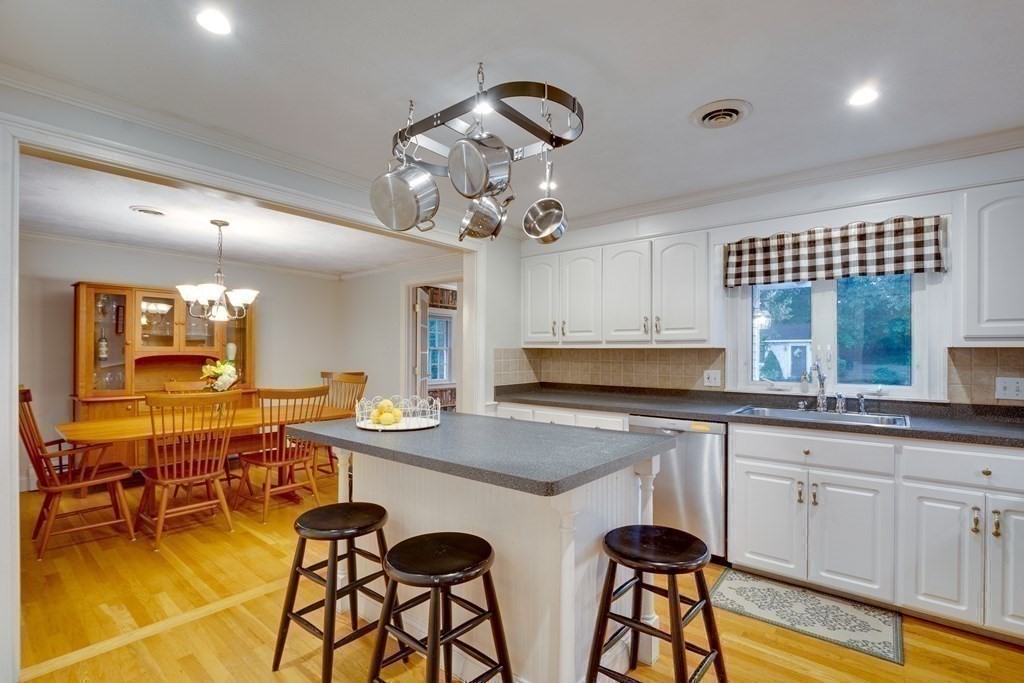 11 Milepost Road Reading, MA 01867 - Photo 10 of 29 a view of a kitchen area with furniture and wooden floor
