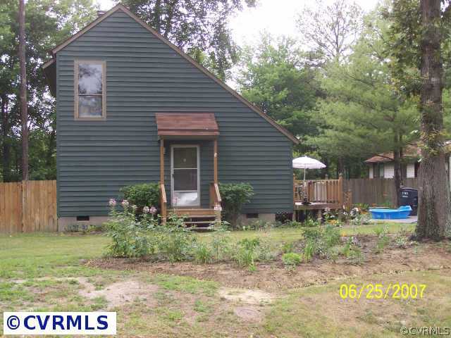 15816 Tri Gate Road Chester, VA 23831 - Photo 2 of 10 a front view of house with garden