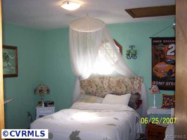 15816 Tri Gate Road Chester, VA 23831 - Photo 8 of 10 a bedroom with a bed and a window