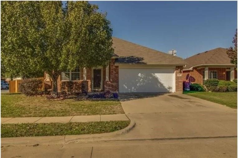 2428 Poplar Spring Road Fort Worth, TX 76123 - Photo 1 of 1 View of front facade featuring brick siding, concrete driveway, a garage, and a front lawn
