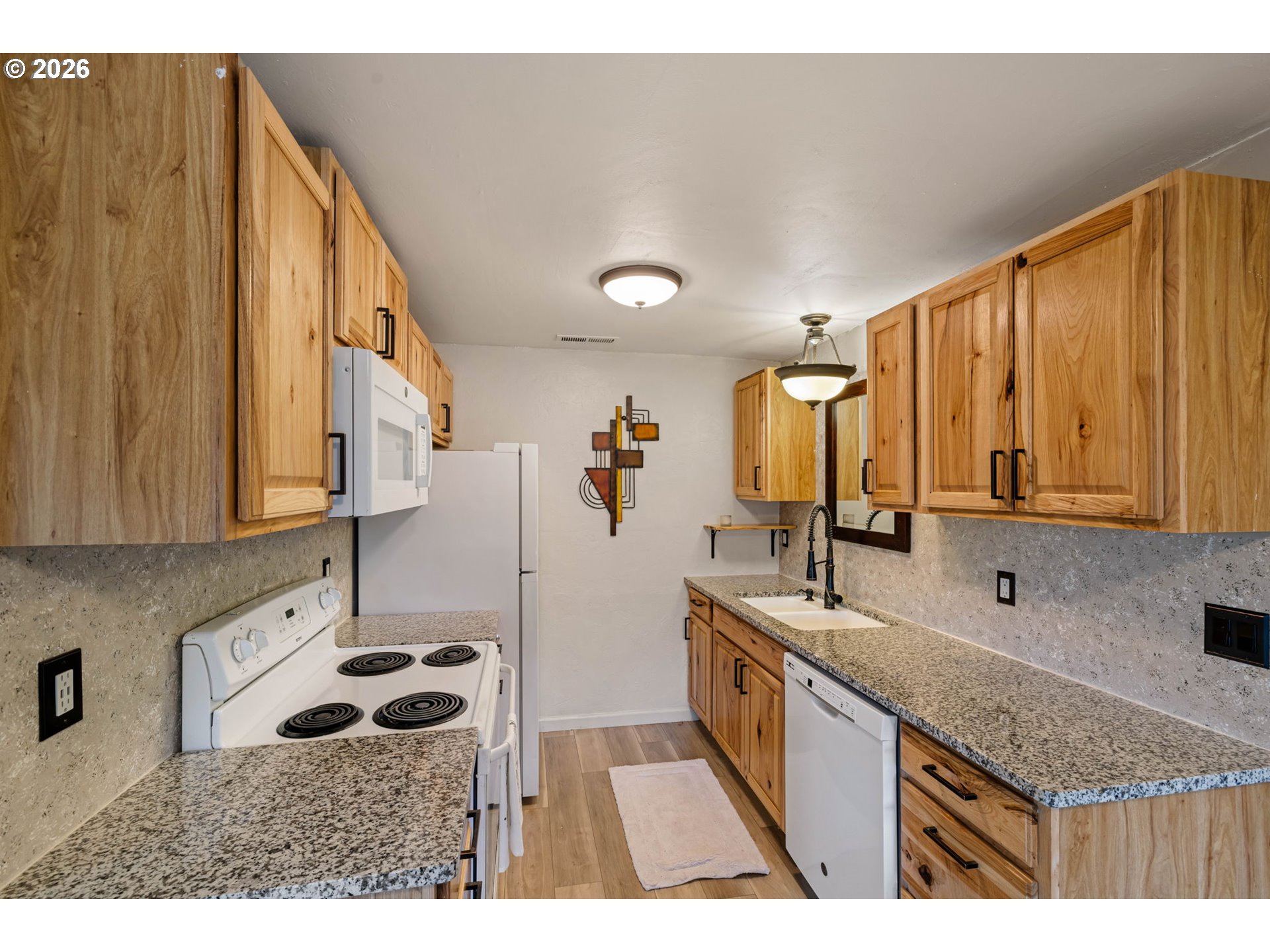 1519 Taney Street Eugene, OR 97402 - Photo 11 of 39 a kitchen with a sink stove and cabinets
