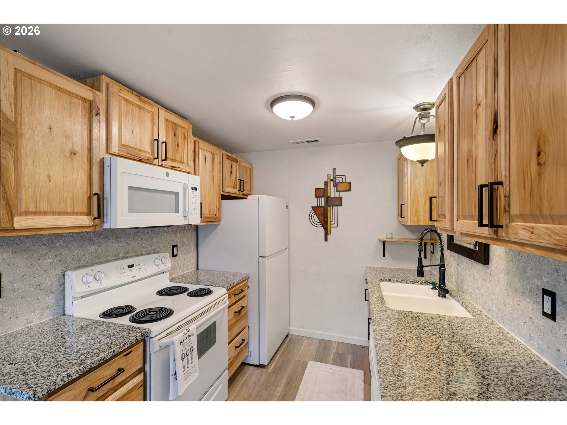 1519 Taney Street Eugene, OR 97402 - Photo 12 of 39 a kitchen with a sink a stove and a refrigerator