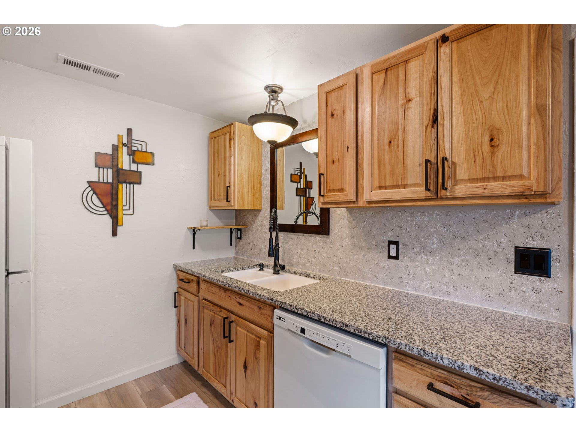 1519 Taney Street Eugene, OR 97402 - Photo 13 of 39 a kitchen with a sink cabinets and a wooden floor