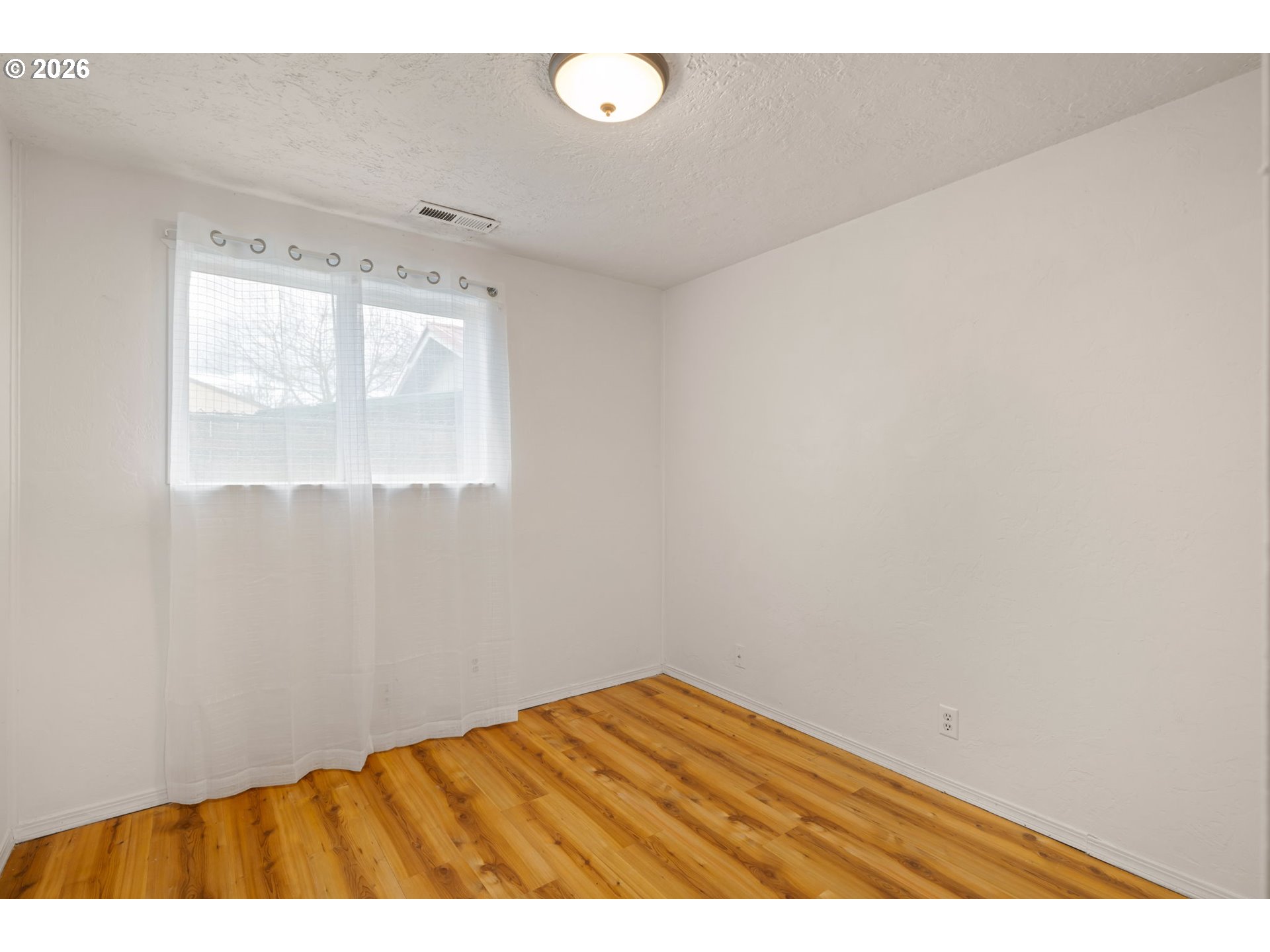 1519 Taney Street Eugene, OR 97402 - Photo 19 of 39 a view of wooden floor in an empty room