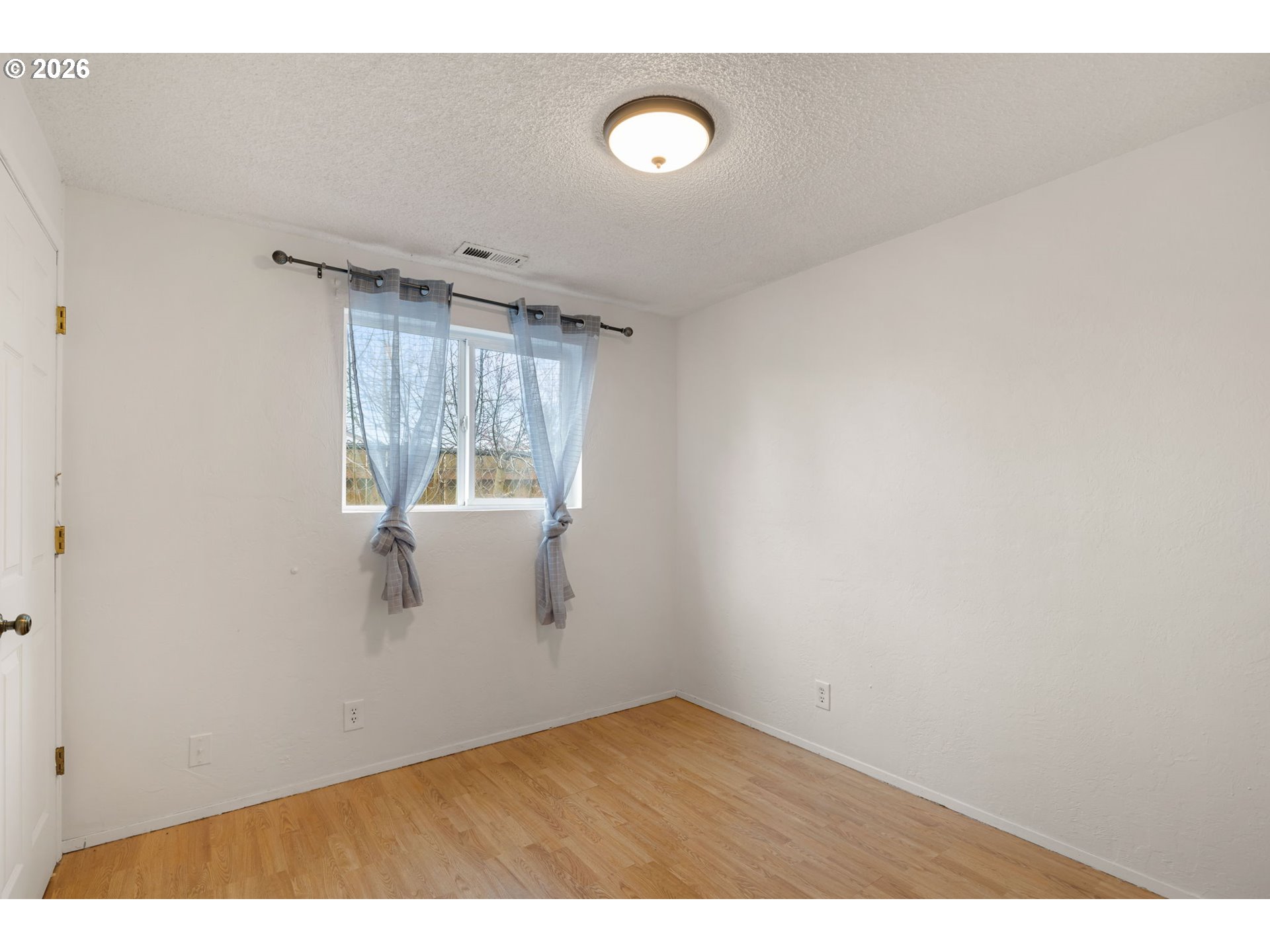 1519 Taney Street Eugene, OR 97402 - Photo 22 of 39 a view of a room with wooden floor and window