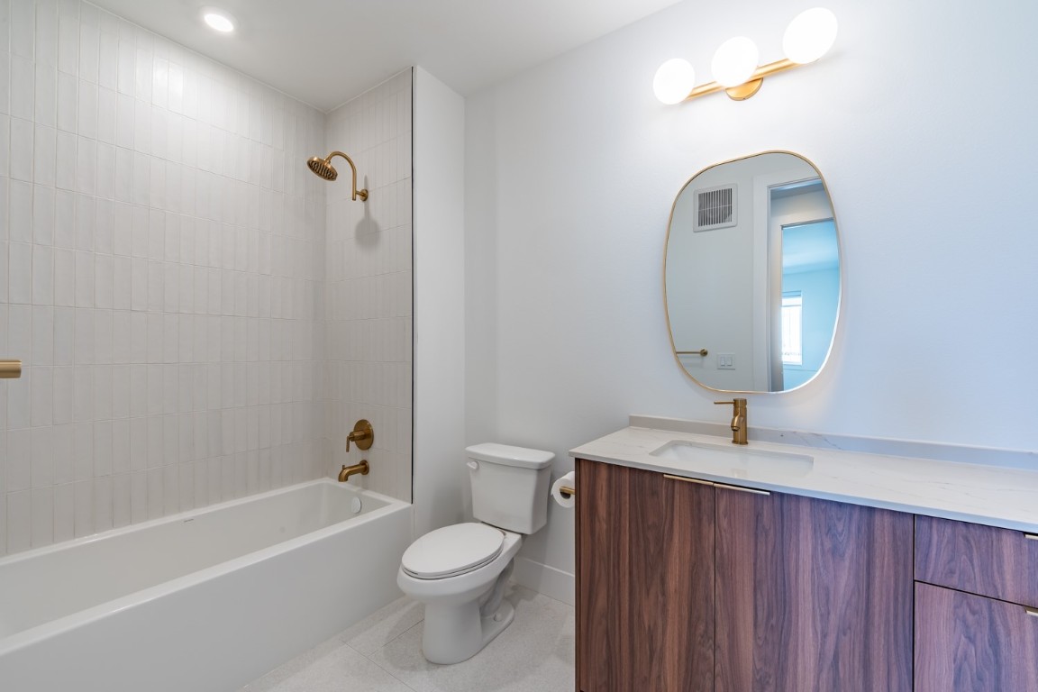 1701 Simond Avenue, Unit 611 Austin, TX 78723 - Photo 14 of 35 a bathroom with a sink a toilet and a mirror