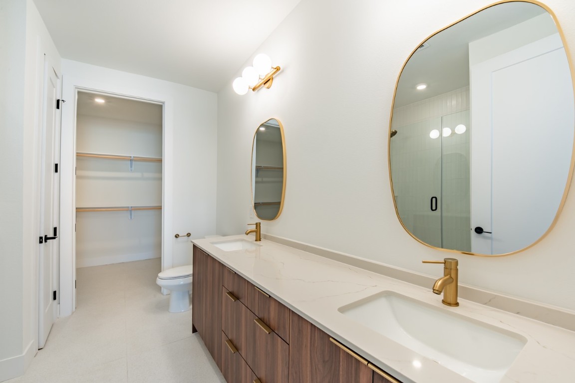 1701 Simond Avenue, Unit 611 Austin, TX 78723 - Photo 16 of 35 a bathroom with a double vanity sink and mirror