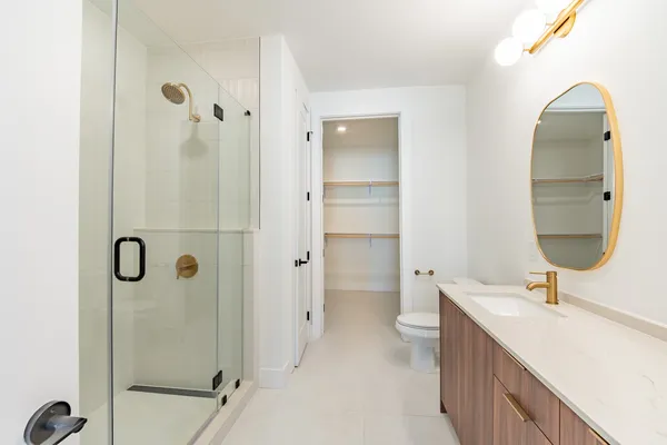 a bathroom with a double vanity sink mirror and shower