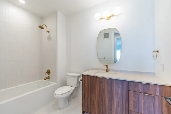 a bathroom with a toilet a sink and bathtub