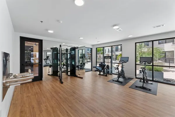 a view of a room with gym equipment and large window