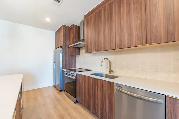 a kitchen with stainless steel appliances granite countertop a sink stove and refrigerator