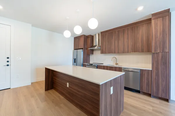 a kitchen with a sink cabinets and wooden floor