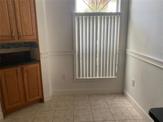 a kitchen with stainless steel appliances a sink a stove a microwave a refrigerator and cabinets