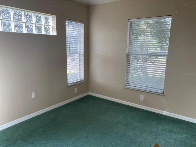 a white toilet sitting next to a window