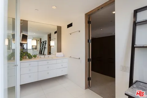 a bathroom with a double vanity sink and mirror