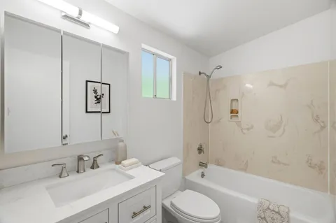a bathroom with a sink toilet tub and shower