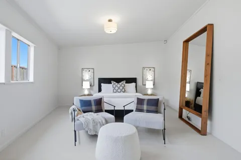 a living room with furniture and a mirror