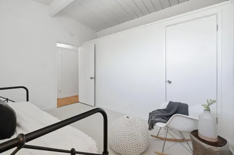 a bedroom with a bed and a chair