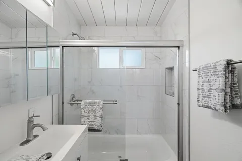 a bathroom with a bathtub and shower