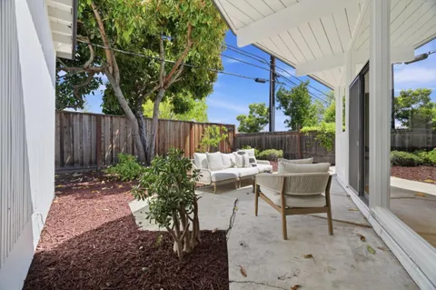 a view of a chair and tables in the patio