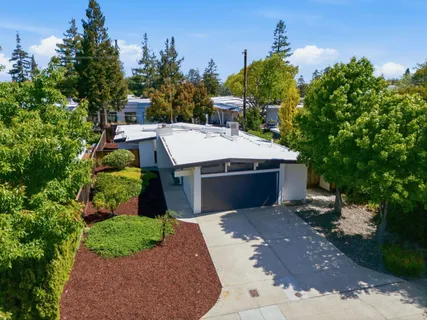 a view of a house with a yard and tree s