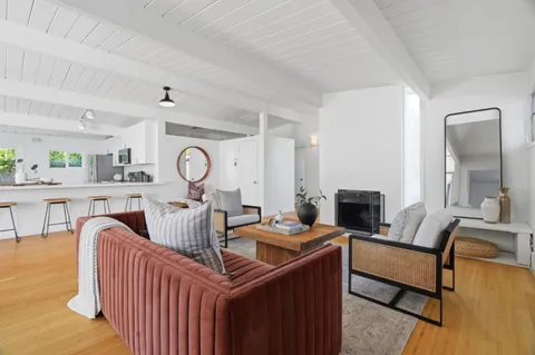 a living room with furniture a fireplace and a table