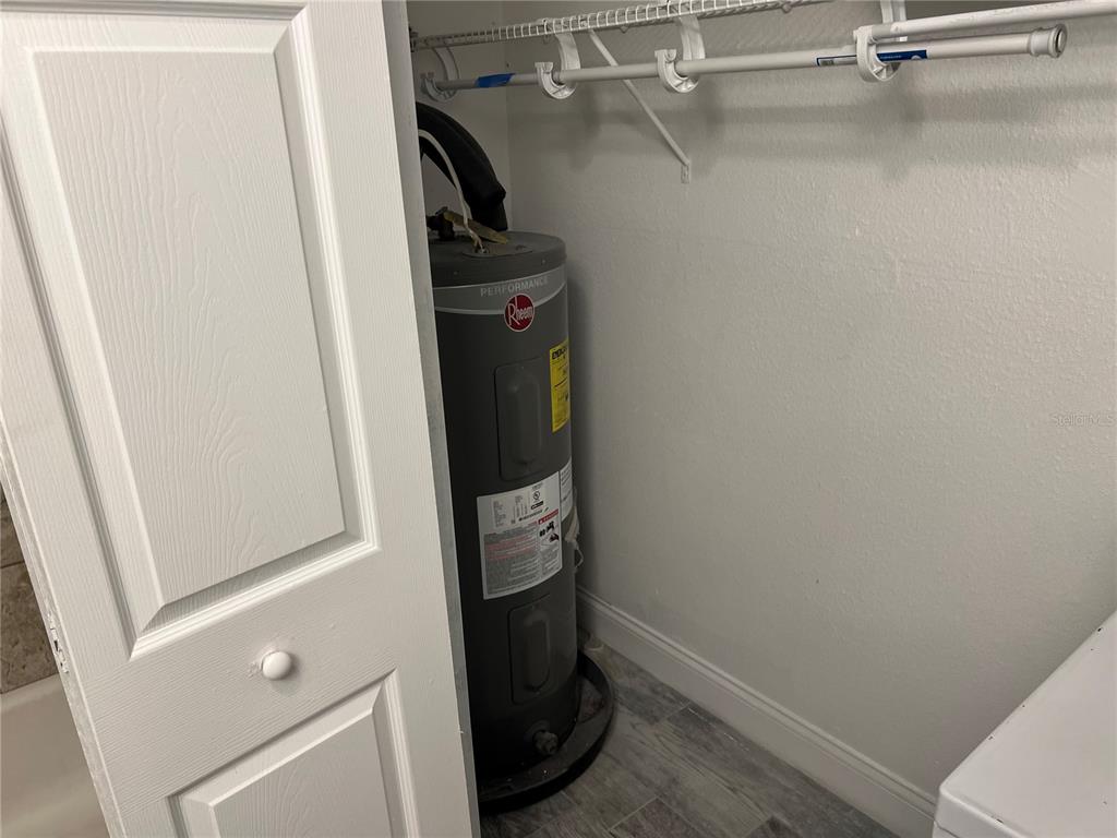 920 Maydell Drive, Unit B Tampa, FL 33619 - Photo 5 of 7 a view of walk in closet with clothes and shoes