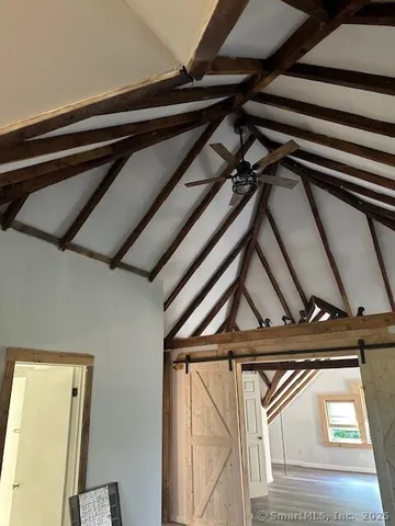 a view of a bedroom with wooden floor and a window