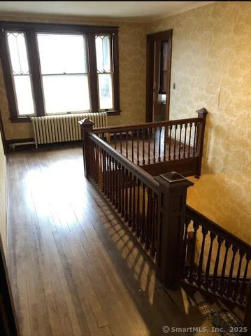 a kitchen with stainless steel appliances a table chairs and a refrigerator