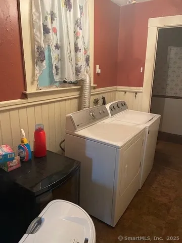a view of a hallway with windows and chandelier
