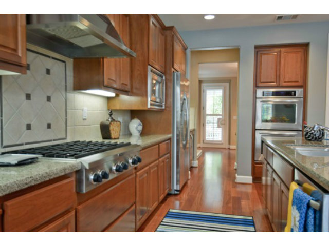 2651 Paige Way San Ramon, CA 94582 - Photo 11 of 24 a kitchen with stainless steel appliances granite countertop a stove a sink dishwasher and cabinets with wooden floor