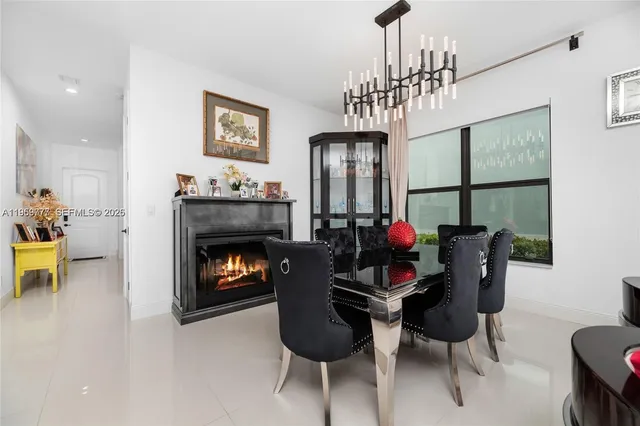 a living room with furniture a chandelier and a fireplace
