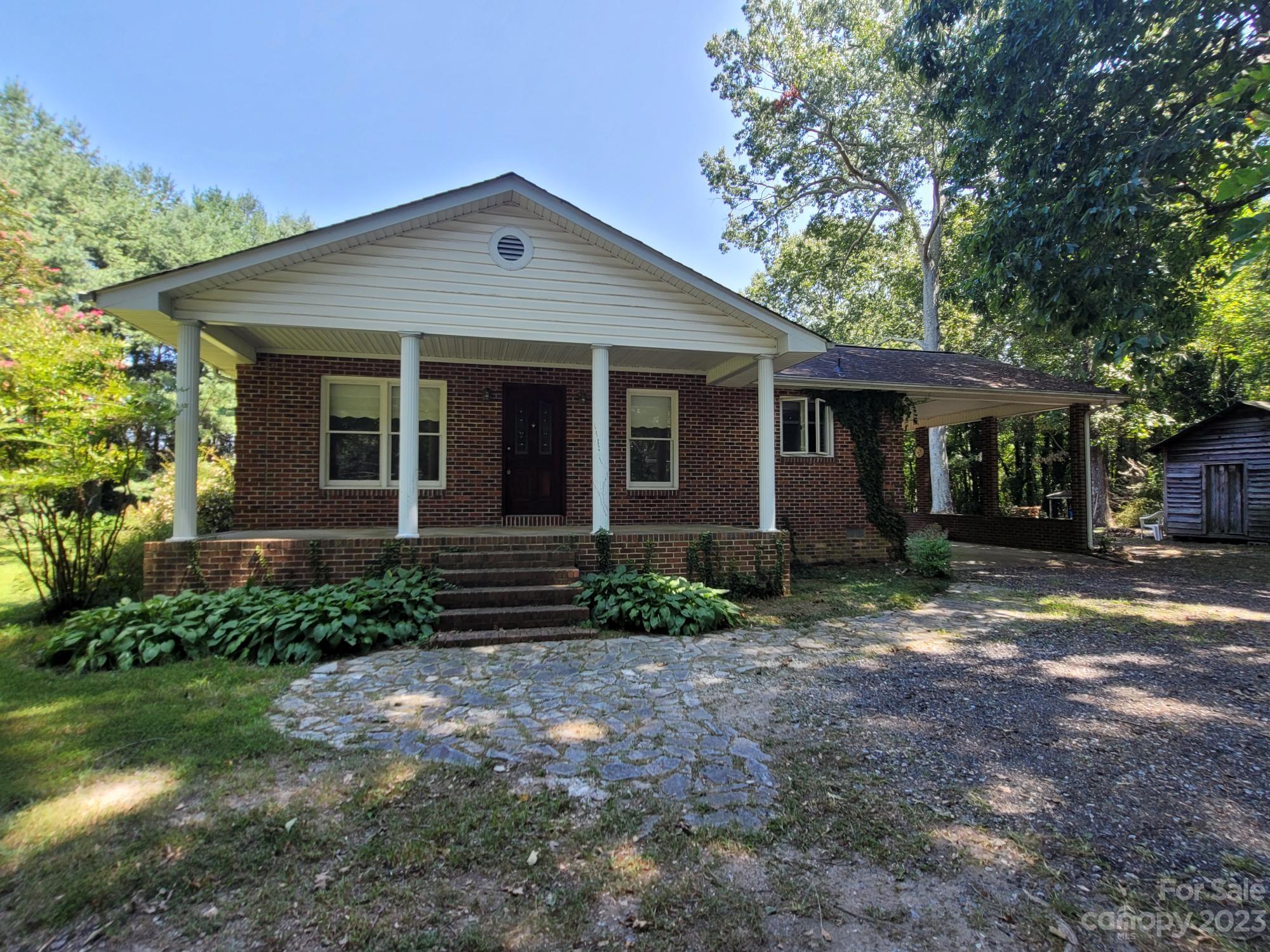 818 St Marks Church Road Bessemer City, NC 28016 - Photo 1 of 48 a front view of a house with garden