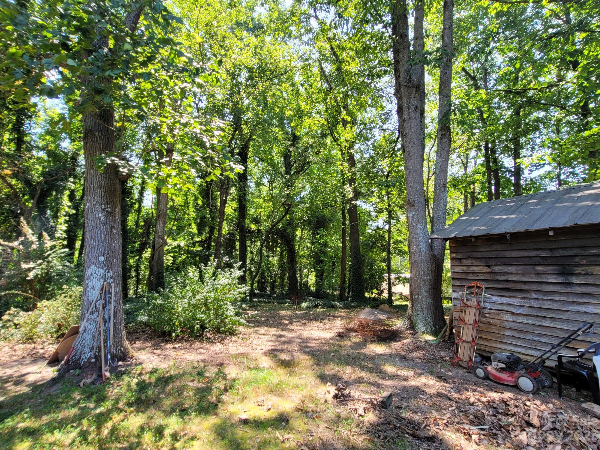 818 St Marks Church Road Bessemer City, NC 28016 - Photo 11 of 48 a view of a backyard with a tree