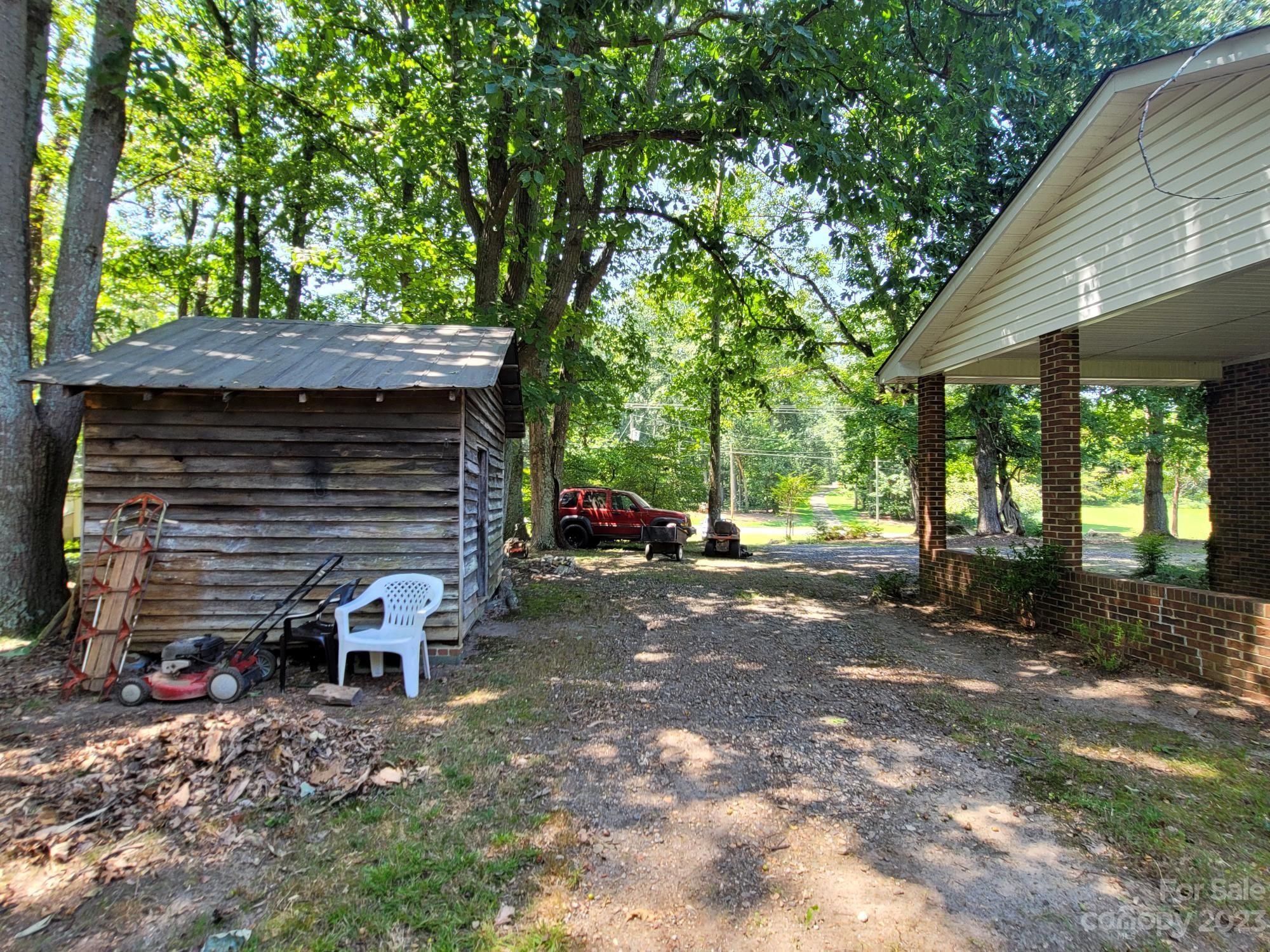 818 St Marks Church Road Bessemer City, NC 28016 - Photo 12 of 48 a view of a house with a yard and tree