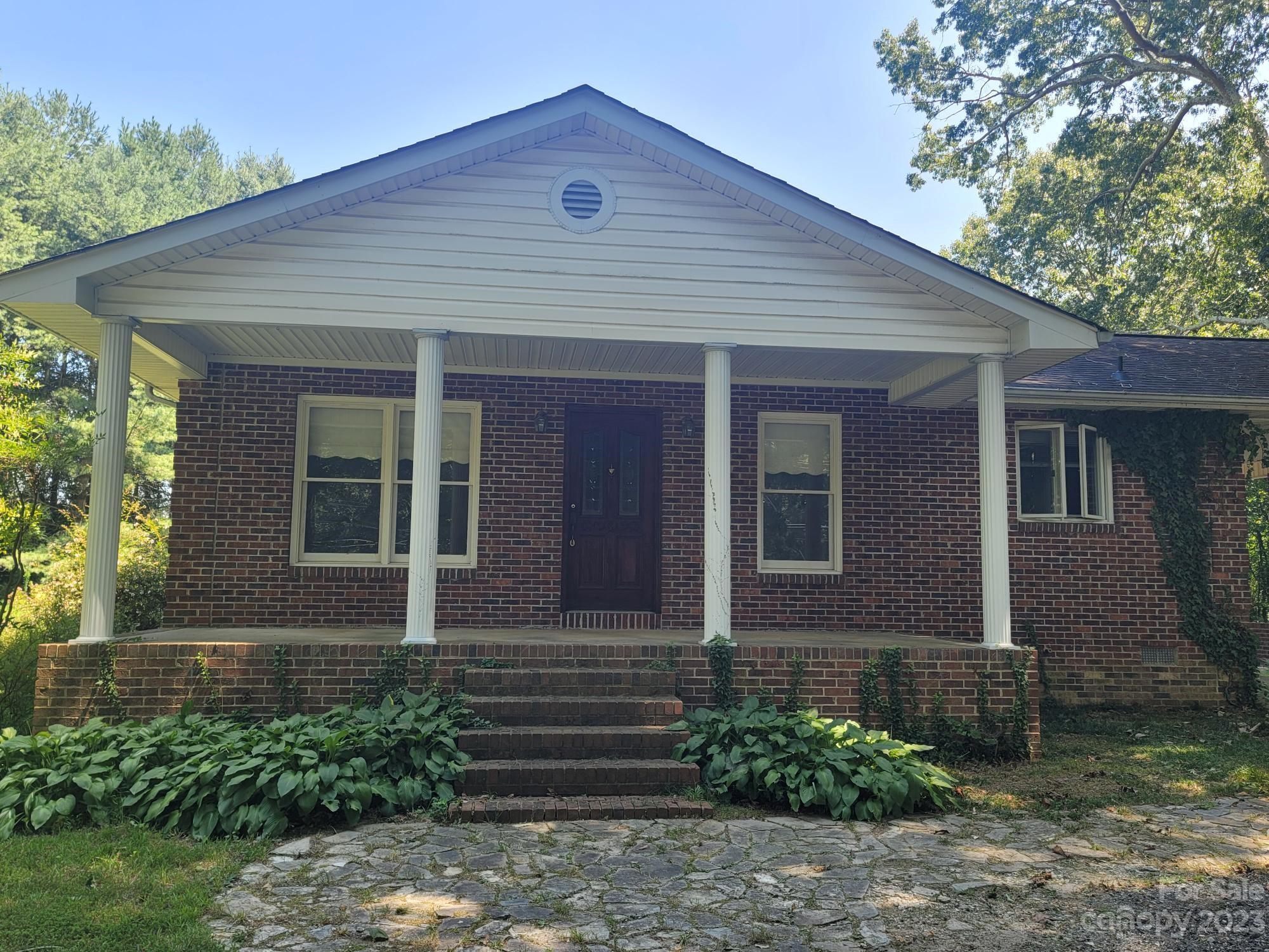 818 St Marks Church Road Bessemer City, NC 28016 - Photo 15 of 48 a front view of a house with garden