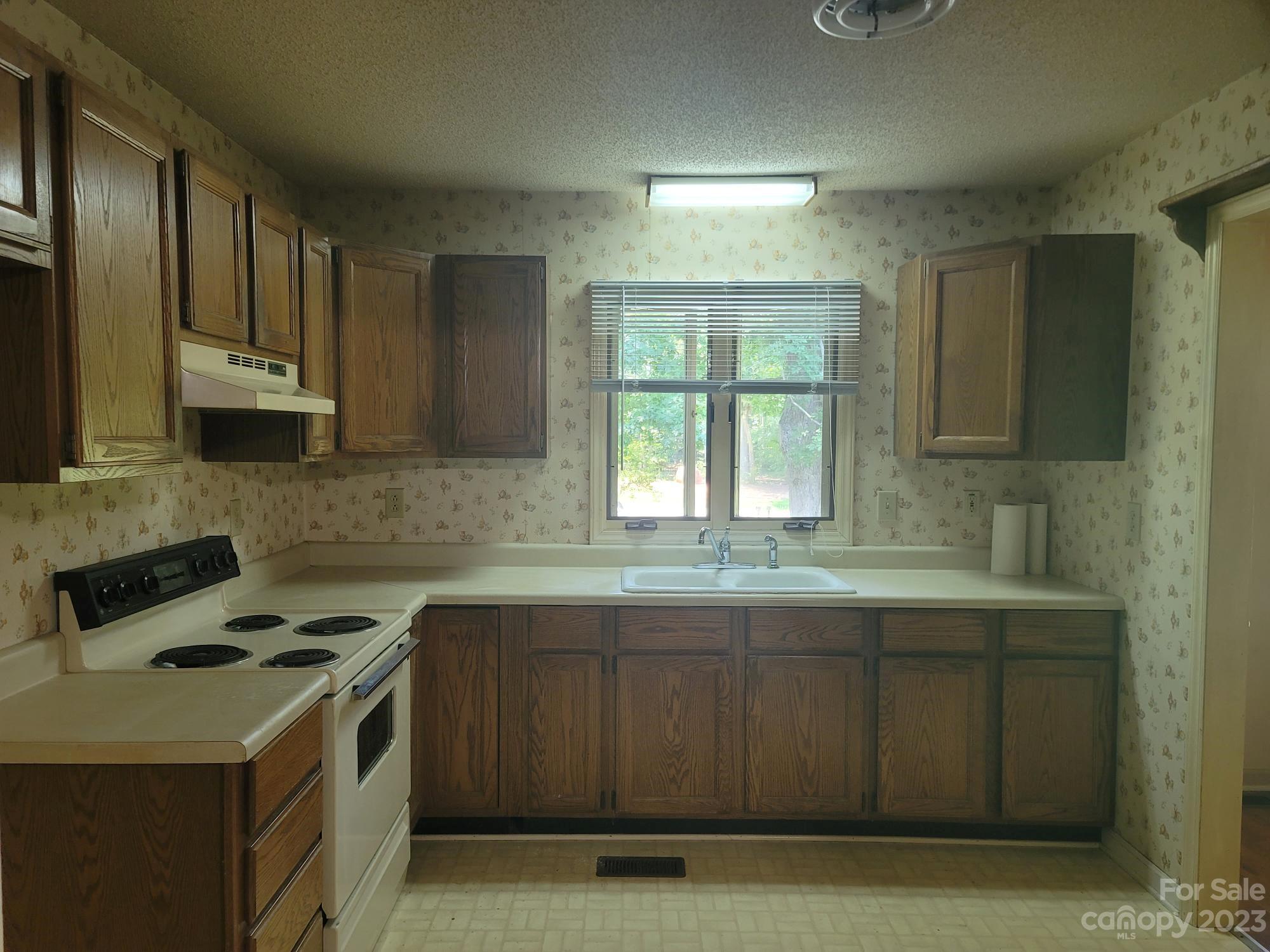 818 St Marks Church Road Bessemer City, NC 28016 - Photo 17 of 48 a kitchen with stainless steel appliances a sink stove and cabinets