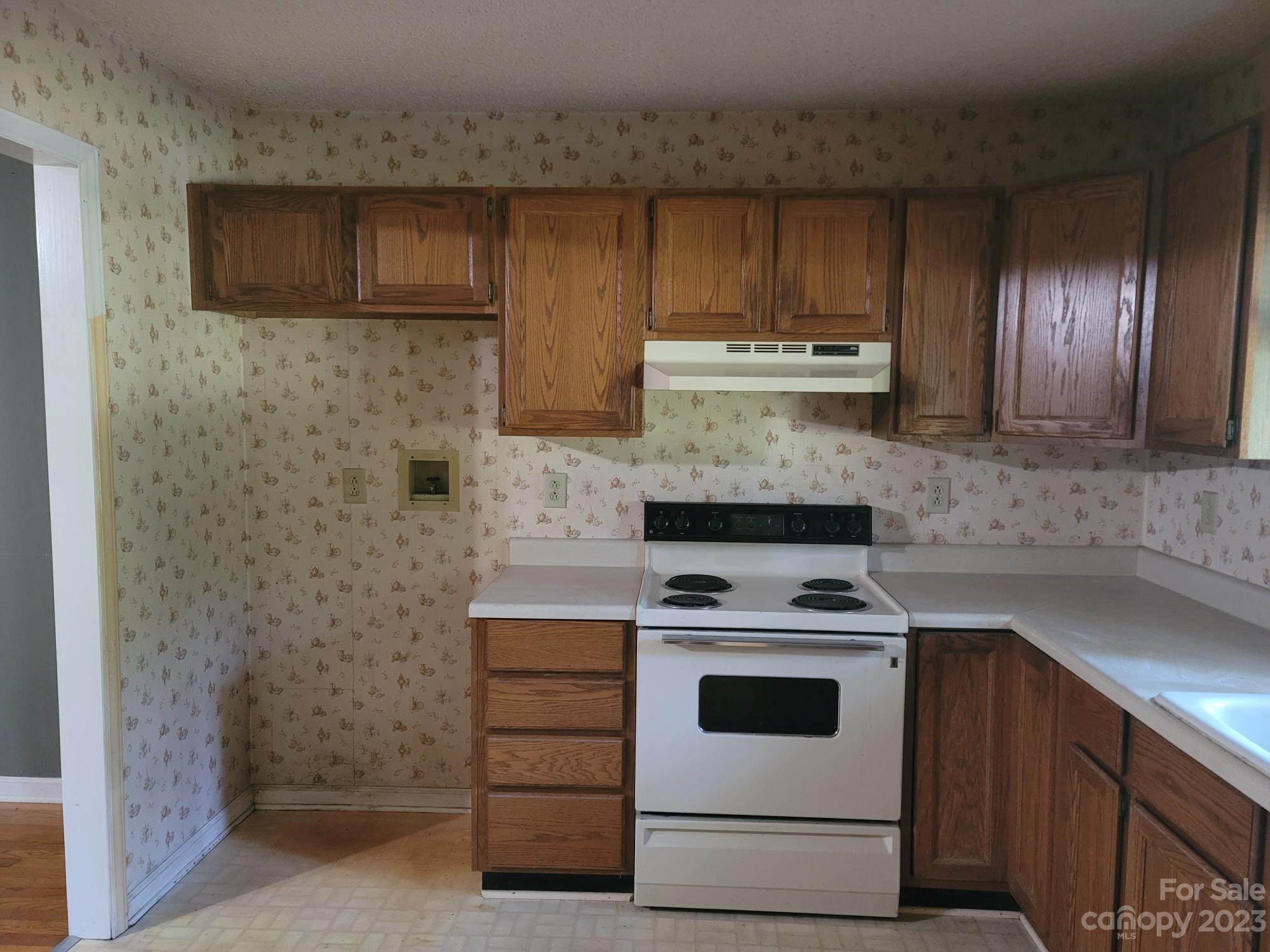 818 St Marks Church Road Bessemer City, NC 28016 - Photo 18 of 48 a kitchen with granite countertop wood cabinets and stainless steel appliances