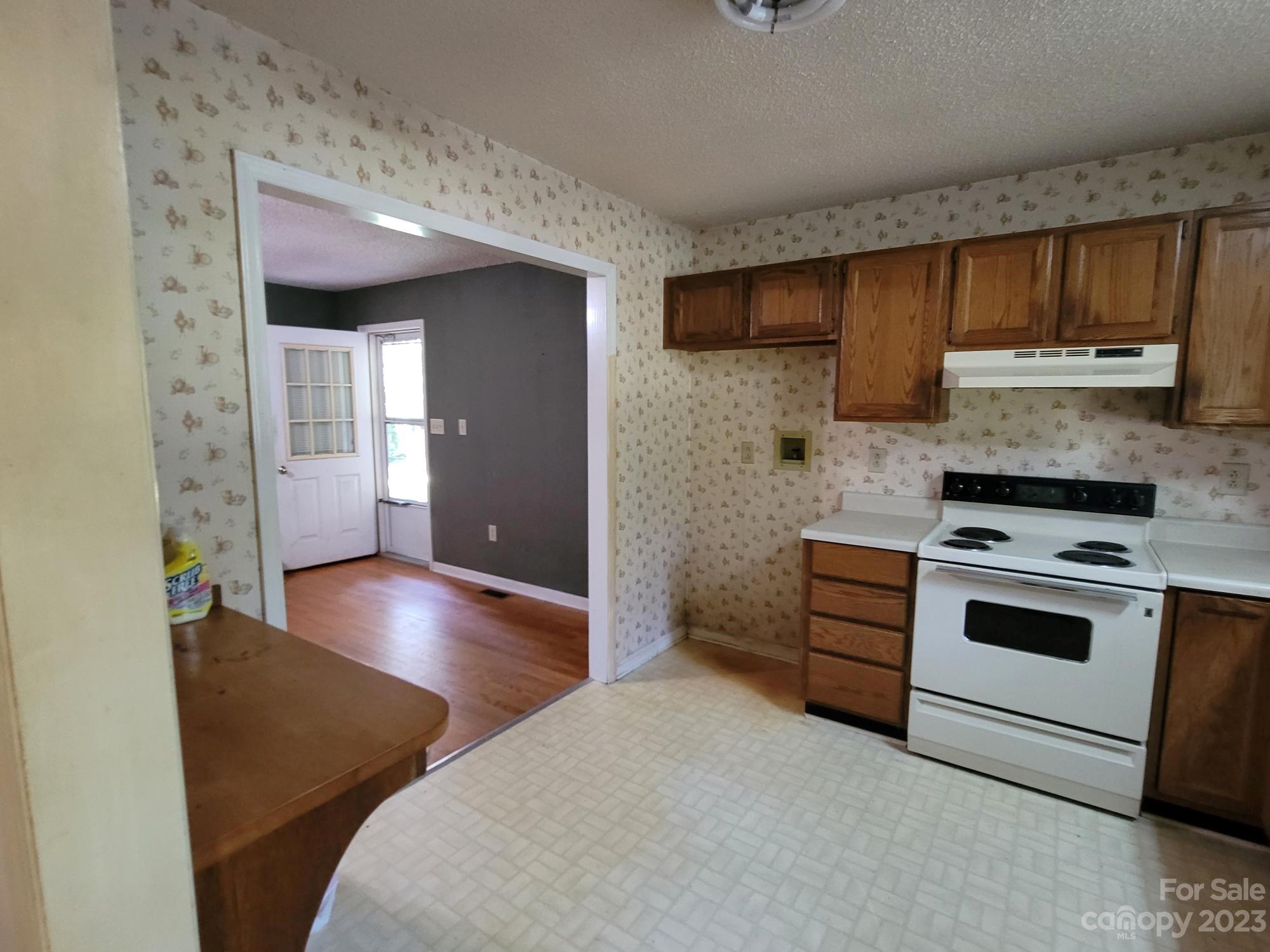818 St Marks Church Road Bessemer City, NC 28016 - Photo 19 of 48 a kitchen with stainless steel appliances a stove and a refrigerator