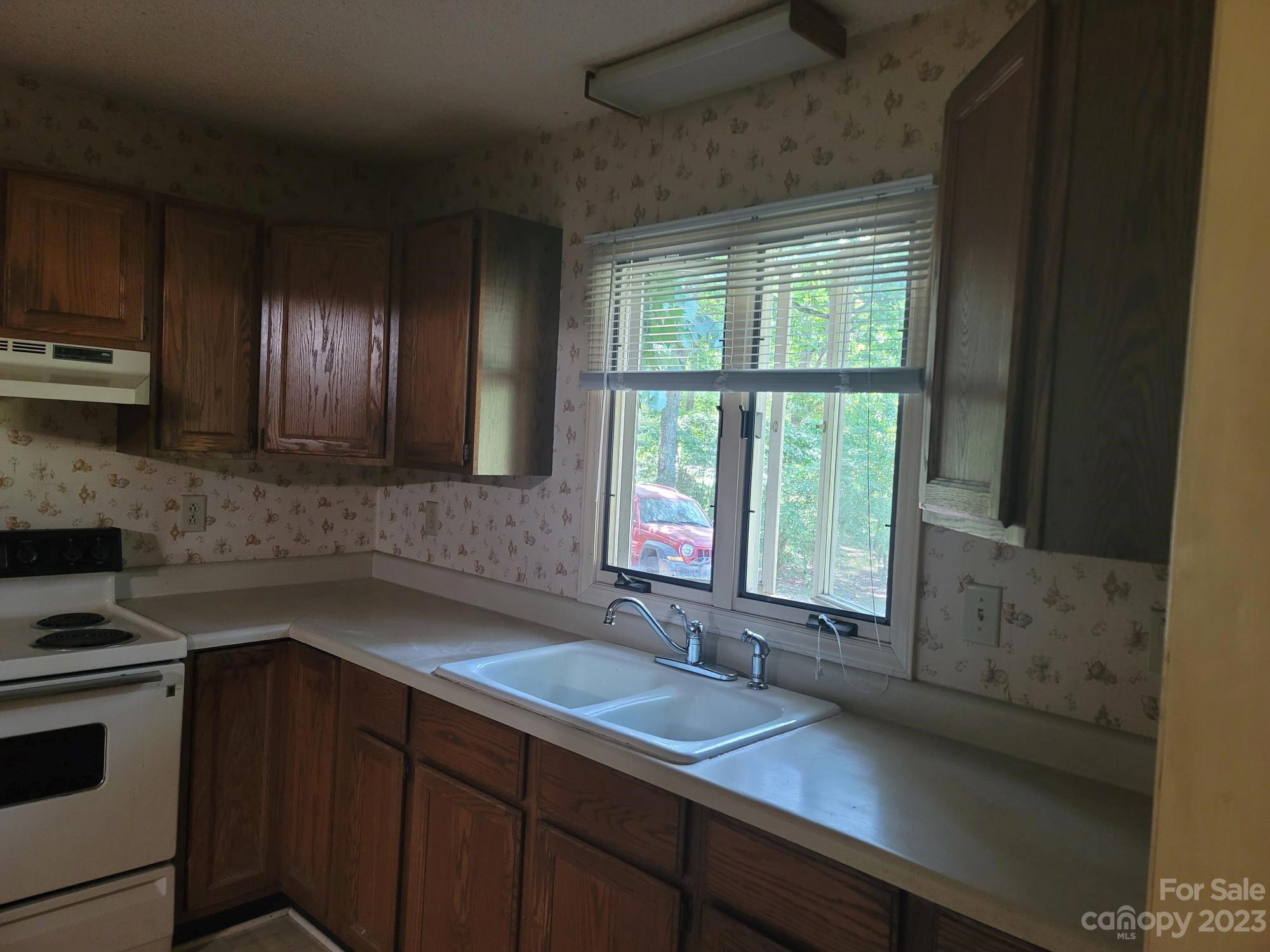818 St Marks Church Road Bessemer City, NC 28016 - Photo 20 of 48 a kitchen with a sink and large window