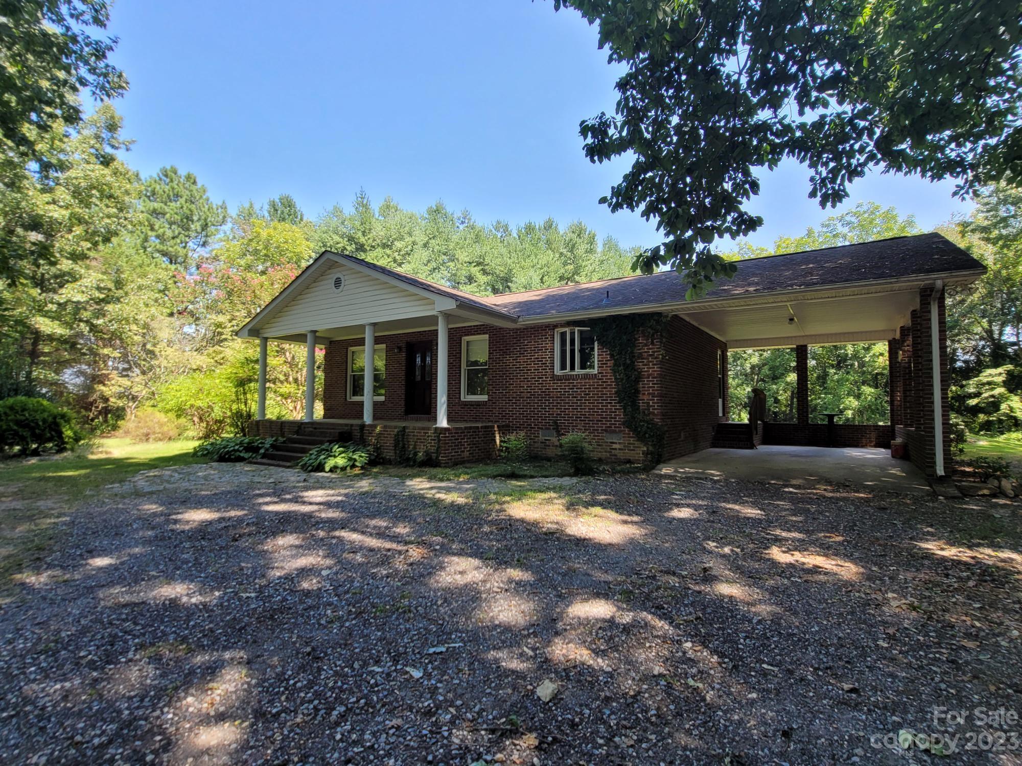 818 St Marks Church Road Bessemer City, NC 28016 - Photo 2 of 48 a front view of a house with a garden