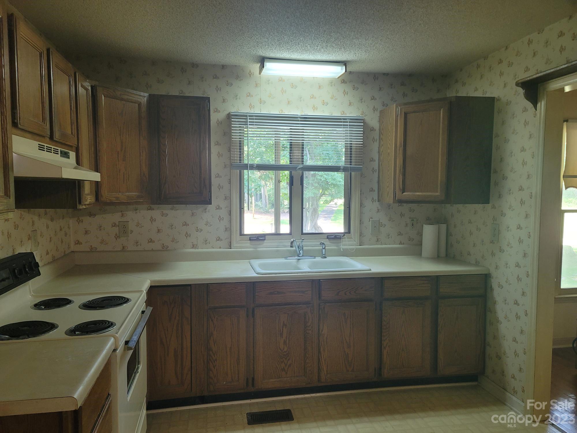 818 St Marks Church Road Bessemer City, NC 28016 - Photo 22 of 48 a kitchen with stainless steel appliances a sink stove and cabinets